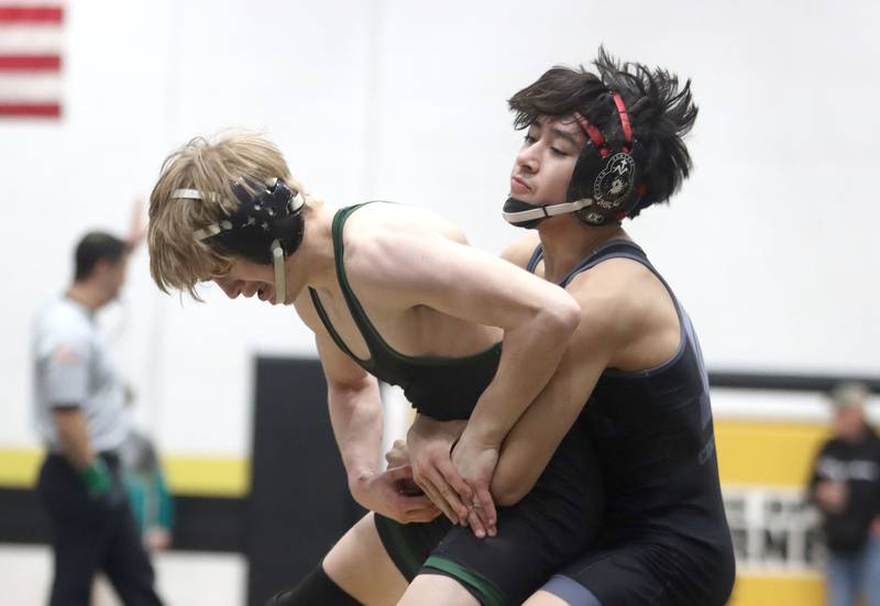 Christopher Talbert of Crystal Lake South, left, battles Diego Martinez of Marian at 106 pounds in boys wrestling IHSA Class 2A Regional championship bout action on Saturday, Jan. 31, 2026, at Harvard High School in Harvard.