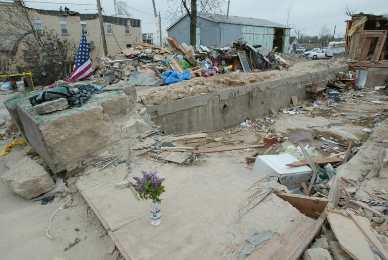 Flowers and an American flag are placed near the entrance to the Milestone Tap that was leveled by the tornado on April 20, 2004 downtown Utica.