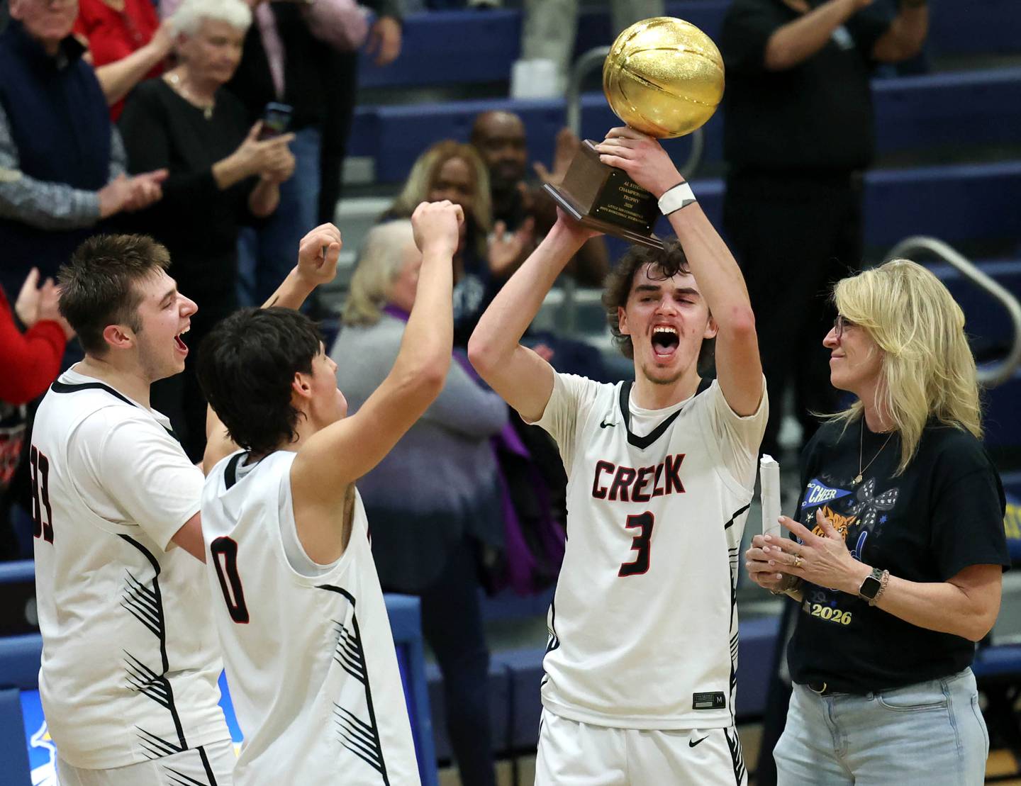 Indian Creek's Logan Schrader accepts the Little 10 Conference championship trophy Friday, Feb. 6, 2026, after their win over IMSA at Somonauk High School.