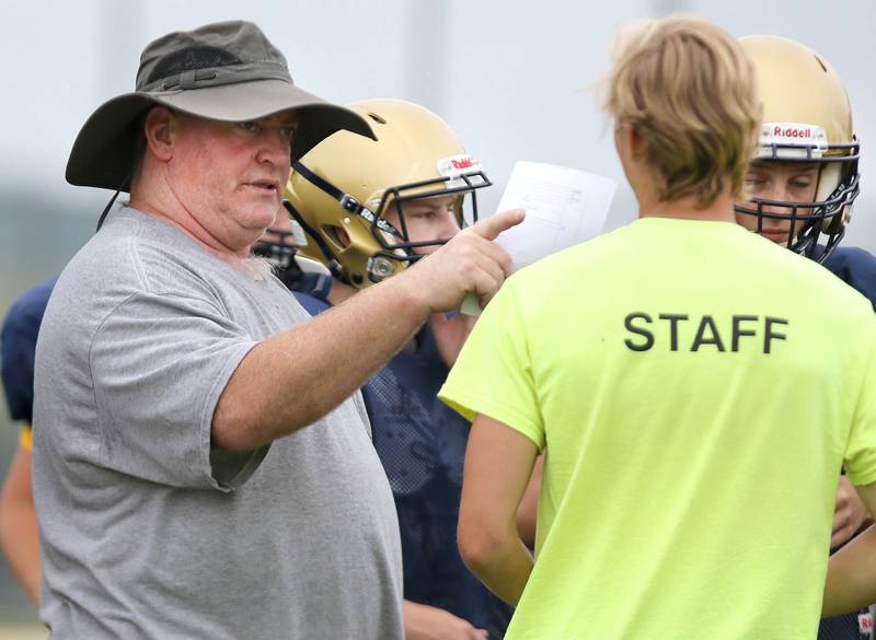 New Hiawatha head football coach Kenny McPeek talks to an assistant during practice Wednesday, August 9, 2023, at the school in Kirkland.