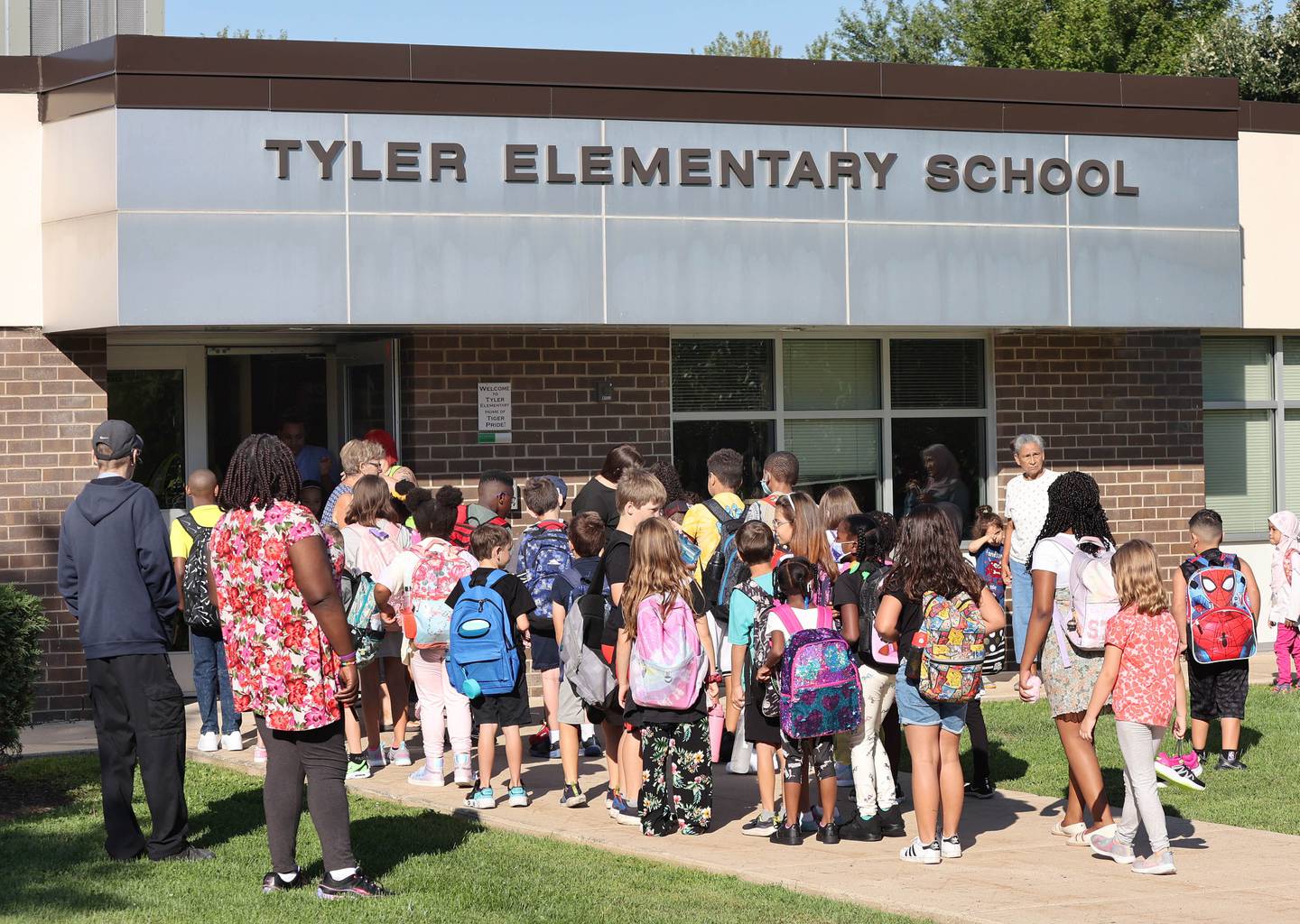Students head into the school Thursday, Aug. 18, 2022, for their first day at Tyler Elementary in DeKalb.