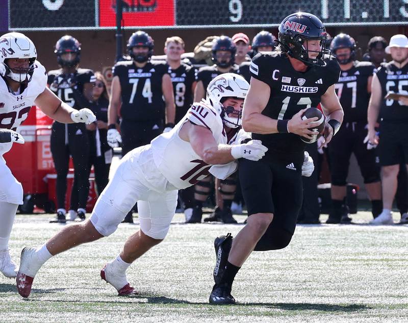 Northern Illinois' Rocky Lombardi is brought down from behind by Southern Illinois' Colin Bohanek during their game Saturday, Sept. 9, 2023, in Huskie Stadium at NIU in DeKalb.