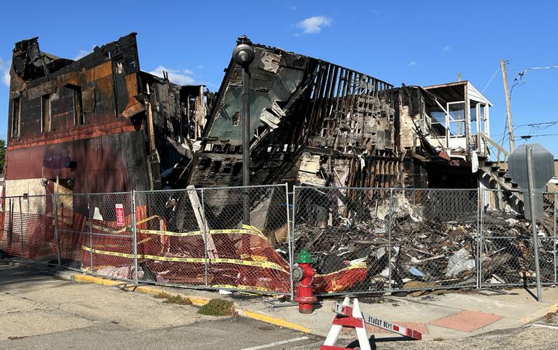 The charred remains of two downtown buildings in Mt. Morris stand at the corner of Wesley Avenue and East Main Street on Sunday, Sept. 29, 2024. Village officials say a demolition permit has been requested for the two buildings at 1 N. Wesley Ave. and 3 N. Wesley Ave., that were destroyed by an April fire.