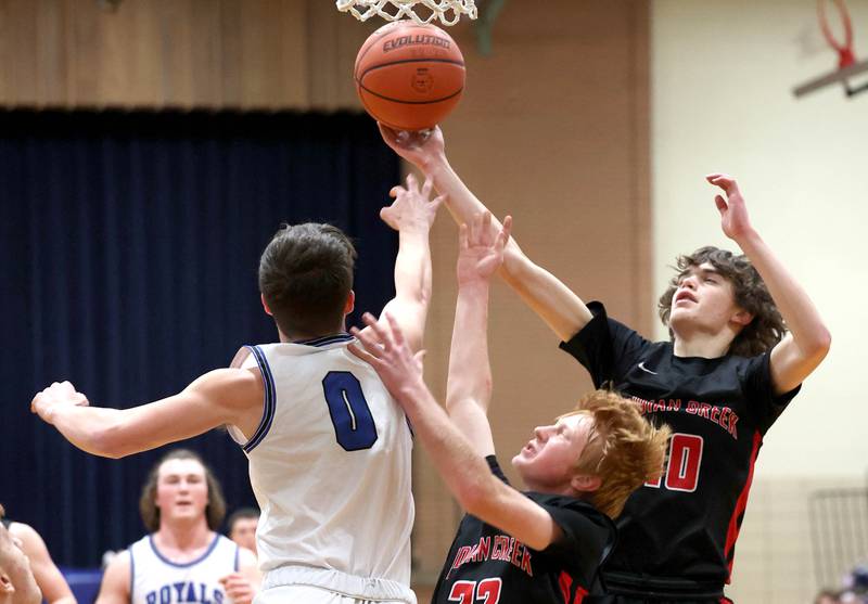 Hinckley-Big Rock's Landon Roop and Indian Creek's Tyler Bogle and Logan Schrader go after a rebound during their game Tuesday, Jan. 31, 2023, in the Little 10 Conference Basketball Tournament at Somonauk High School.