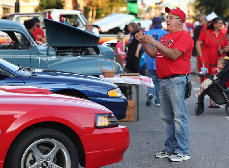 Visitors enjoy checking out some of the classic vehicles in the car show Thursday, Oct. 2, 2025, during the Huskie Homecoming Block Party in downtown DeKalb.