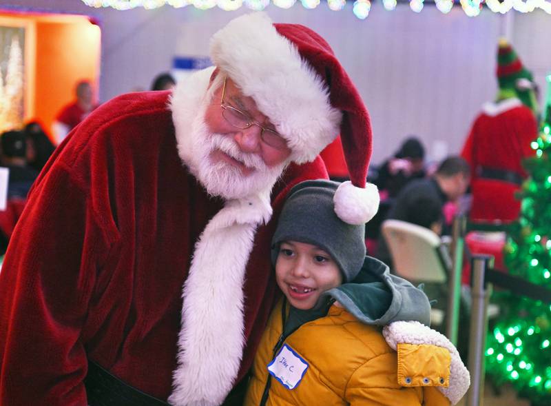 Santa greets Iker Carranza, 9, of Carpentersville during the breakfast at Fox Valley Baptist Church that preceded the Dundee Township Shop with a Cop event at Walmart  on Saturday, Dec. 14, 2024.