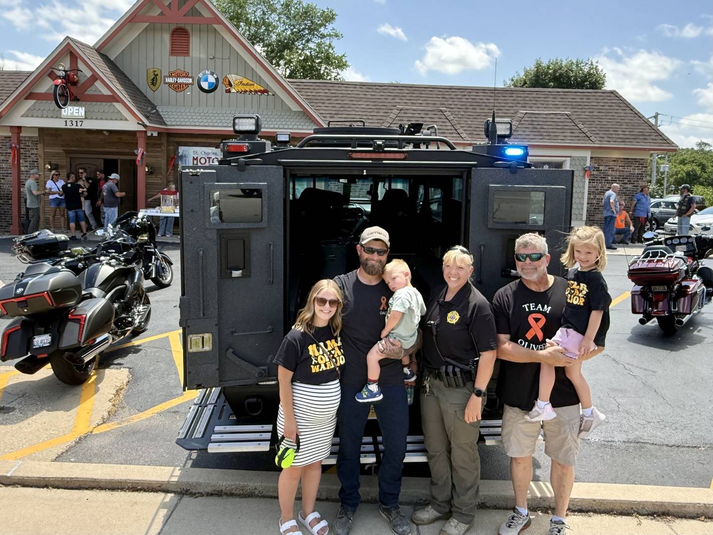 The Olinger family poses with Kane County Deputy Sheriff Susan Deuchler outside the St. Charles Motorcycle Museum at 1317 E Main St. (Route 64) in St. Charles Sunday afternoon, June 22, 2025. (From Left: Sami Olinger, Nathan Olinger, Oliver Olinger, Deuchler, Keith Olinger and Maive Olinger)