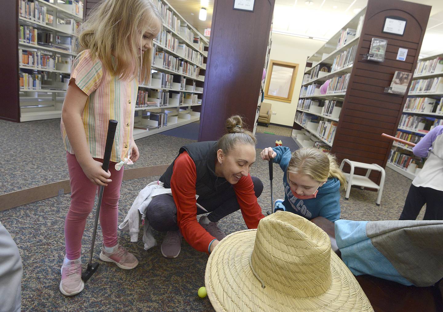 Mini golfers of all ages enjoy the game indoors at Yorkville Library’s annual FunRaiser event