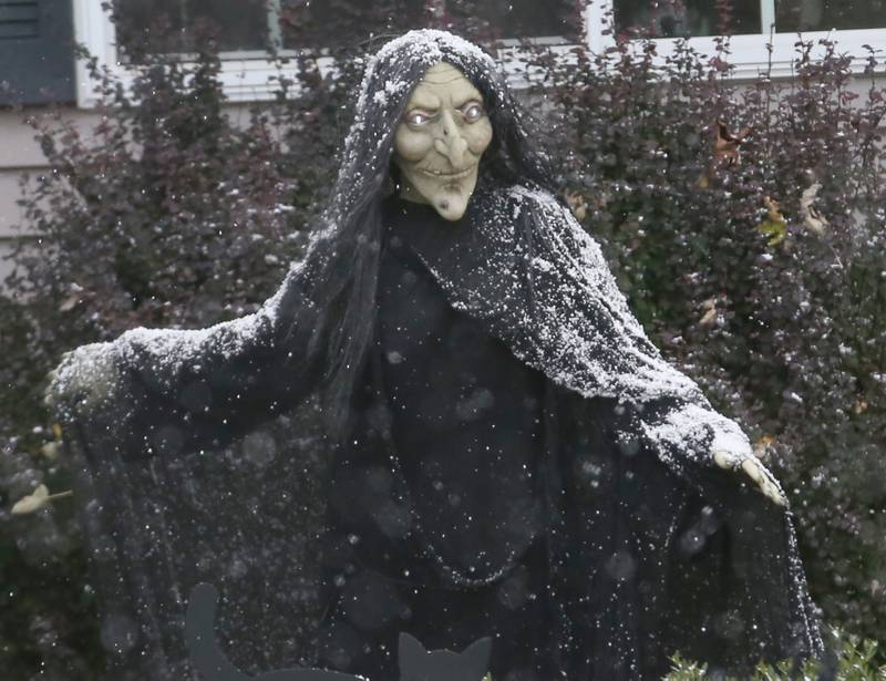 A Halloween decoration is covered in snow on Tuesday, Oct. 31, 2023 on Terrace Drive in Peru.