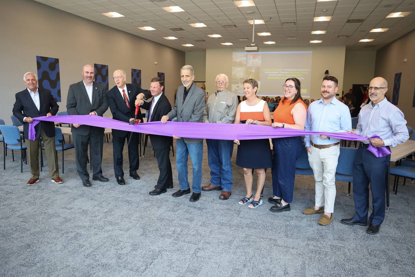 U.S. Representative Bill Foster, D-11, left, and Cornerstone Services President and CEO Ben Stortz hold the scissors for the ribbon cutting ceremony at the new Cornerstone Wellness Center on Tuesday, Aug. 8, 2023 in Joliet.