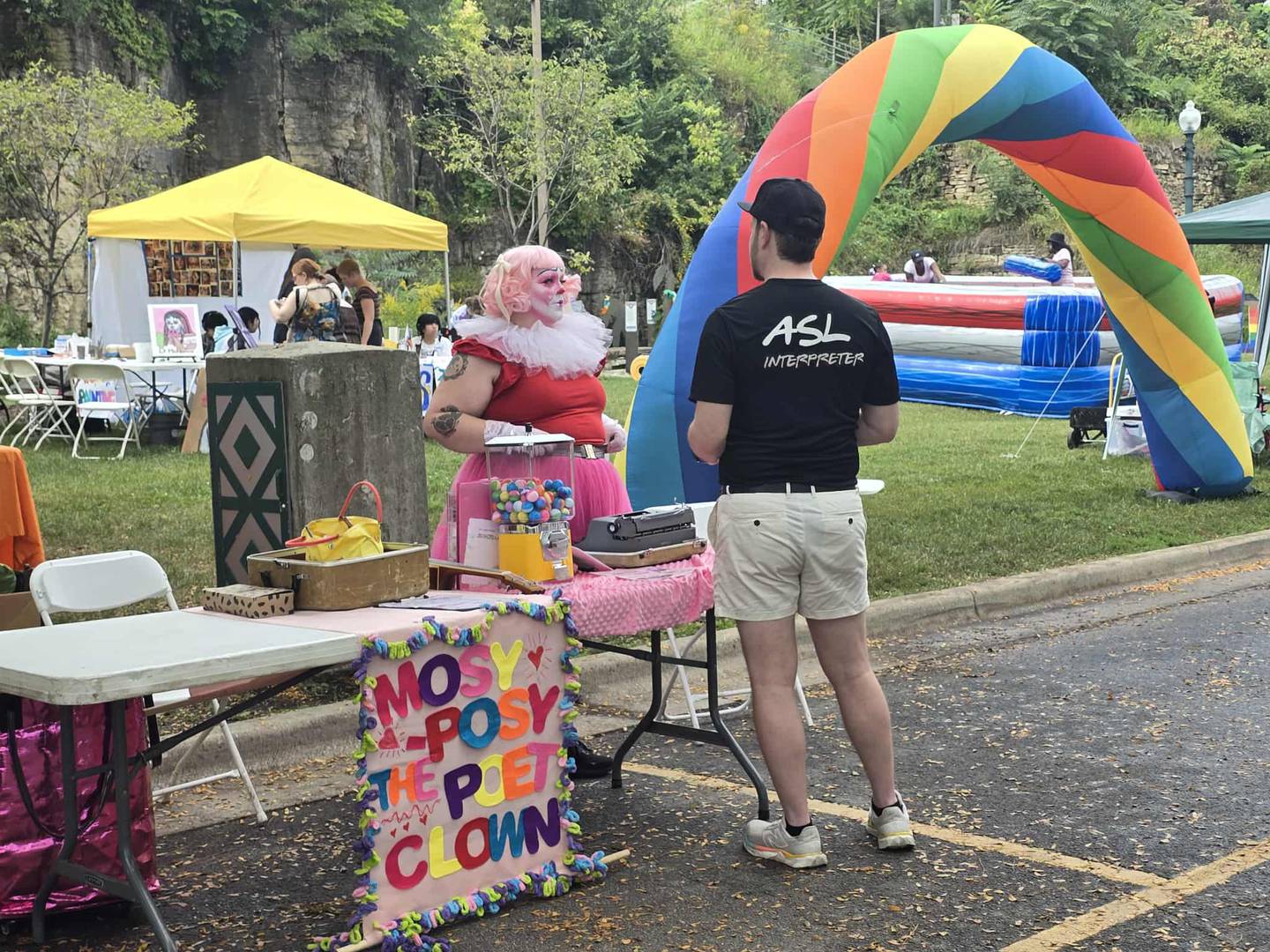 Morganna Van Grin of Chicago, more commonly know as Mosy-Posy the Poet Clown, chats with an attendee at Joliet PrideFest on Saturday, Spet. 20, 2025 at the Billie Limacher Bicentennial Park and Theatre in Joliet.
