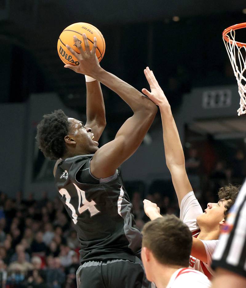 Kaneland's Jeffrey Hassan shoots over the Morton defense Monday, March 9, 2026, during their IHSA Class 3A supersectional matchup in the Convocation Center at Northern Illinois University in DeKalb.
