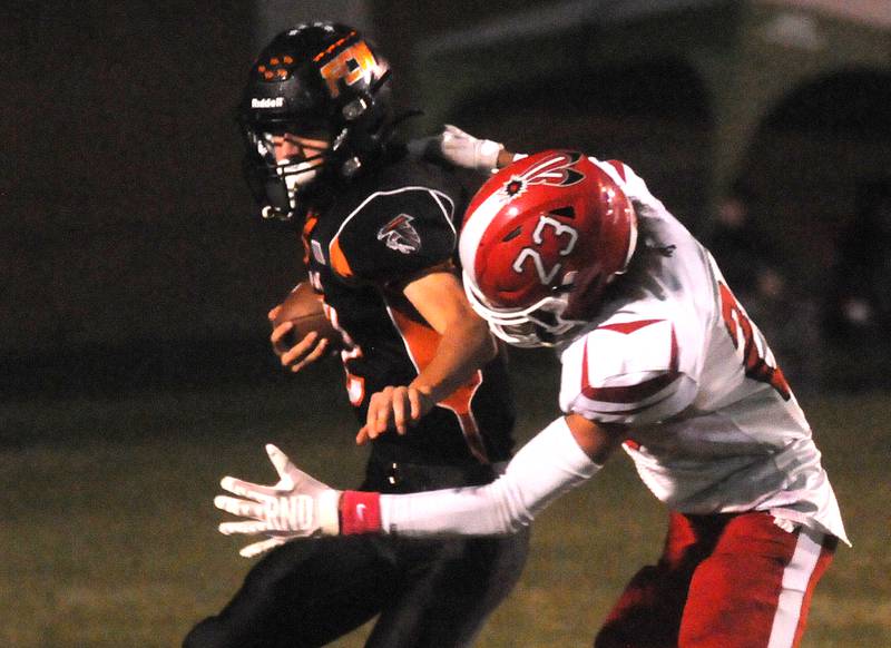 Flanagan-Cornell/Woodland's Seth Jones tries to maneuver past South Beloit's Dez Hampton at Woodland on Friday, Oct. 13, 2023.