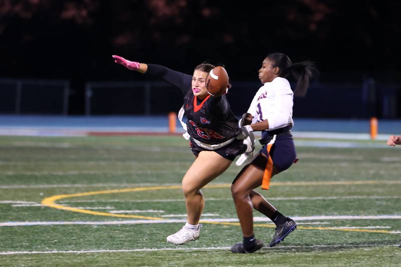Yorkville's Kayla Kersting attempts to dive for a first down as Oswego's Jazmin Hurston grabs her flag during the Foxes' 2-1 overtime victory over Oswego in the IHSA Kankakee Regional championship game on Thursday, Oct. 9, 2025.
