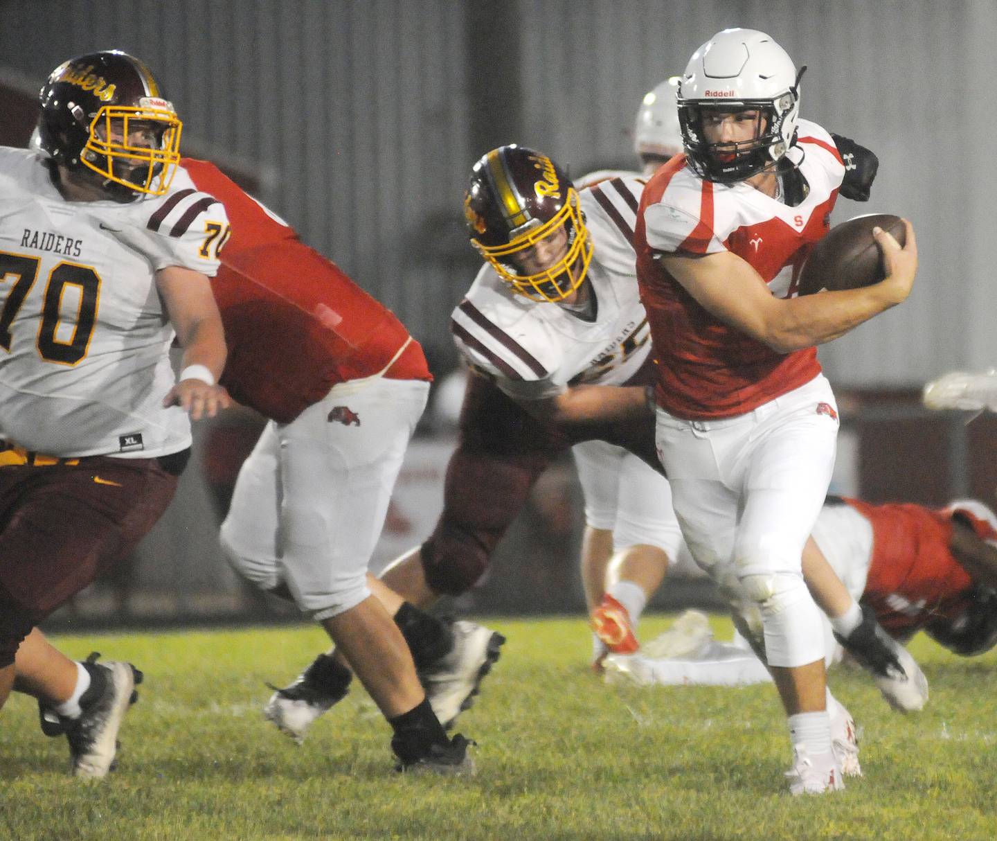 Streator quarterback Christian Benning scrambles against East Peoria at Doug Dieken Stadium during the 2023 season opener.