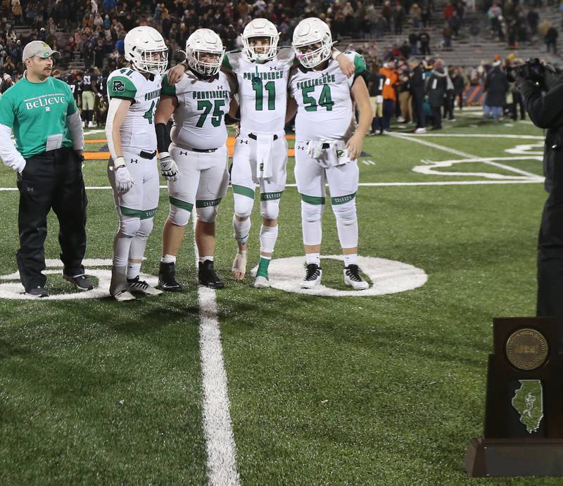Providence Catholic captains Billy Jones, Zack Hesselmann, Jack Tess, and Sean Dee wait for the second place trophy with their head coach Tyler Plantz in the Class 4A state title on Friday, Nov. 25, 2022 at Memorial Stadium in Champaign.