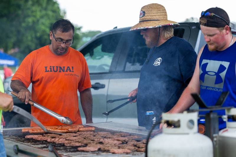(left to right) Laborers Local 393 members Victor Mancilla, Craig Swank and Sam Motley grill burgers and hot dogs at the Touch a Truck event on Sunday, July 27, 2025, at Riverfront Park in Ottawa.