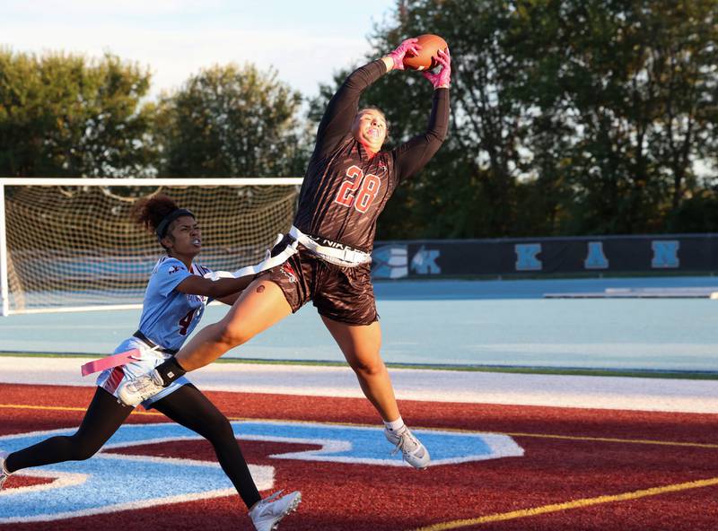 Yorkville's Kayla Kersting catches a touchdown pass ahead of Kankakee's Ivalyce Espinosa during the Foxes' 26-13 victory over Kankakee on Tuesday, Oct. 7, 2025.
