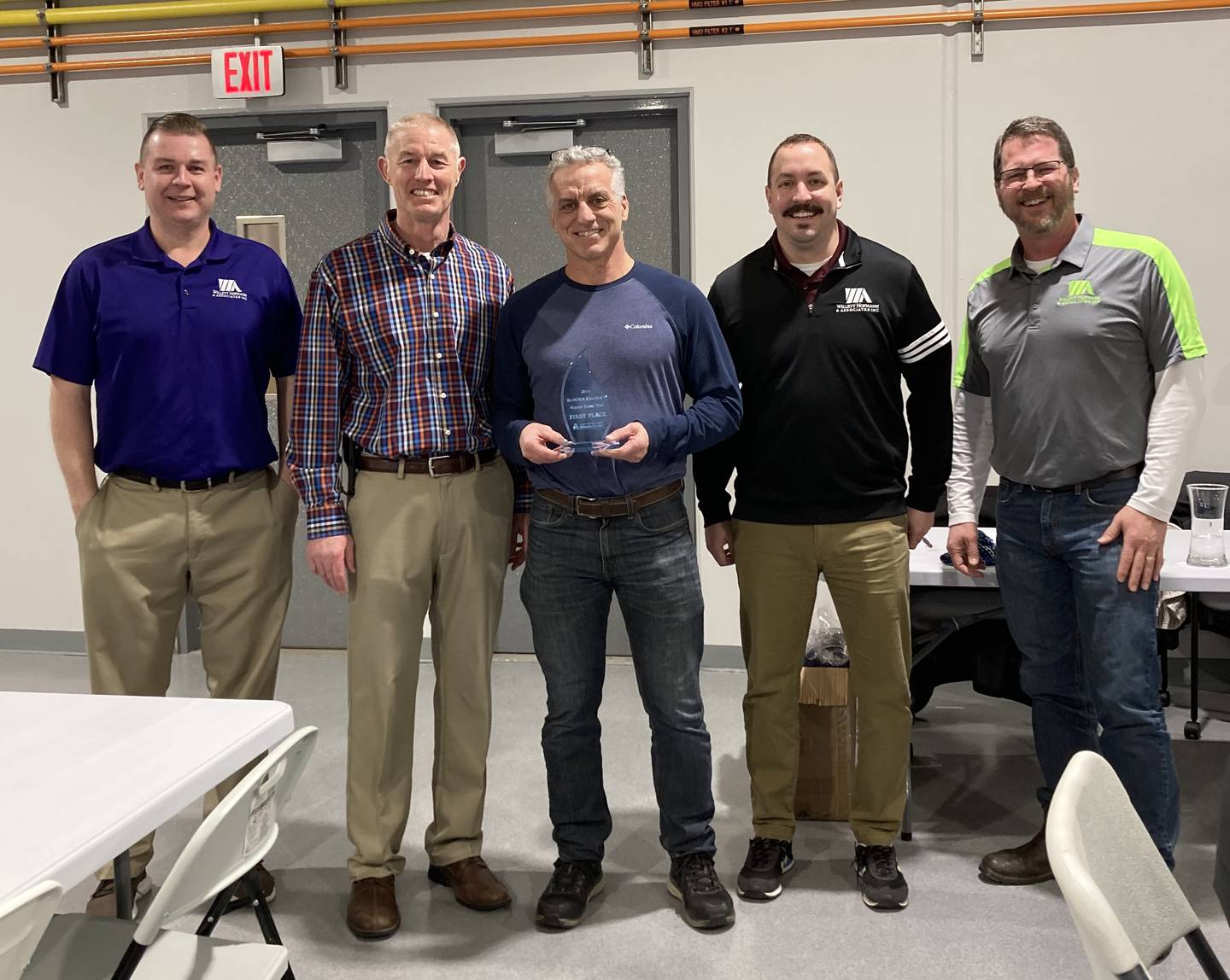 Bryan Faivre (center), city of DeKalb's DeKalb director of utilities and transportation, is presented with the city’s award for taking first place in the Illinois Section American Water Works Association District 1 Water Taste Test Competition on Jan. 26, 2024, in Freeport. He is joined by representatives of the engineering firm Willett Hofmann and Associates, which sponsored the competition.