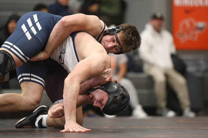 Joliet Catholic’s Mason Bucon brings down Plainfield South’s Ryker Czubak in the Class 3A Minooka Regional 215 pound championship on Saturday, Jan. 31, 2026 in Minooka.