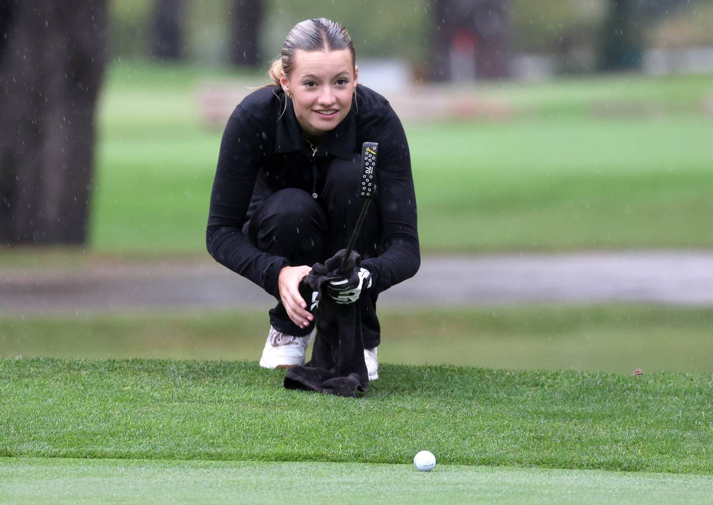 Sycamore DeKalb co-op’s Meadow Lee lines up her putt on the second hole Tuesday, Sept. 24, 2024, during the Interstate 8 girls golf tournament at the Sycamore Golf Club.