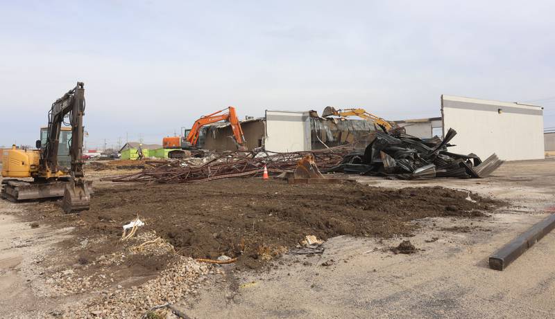 Excavators demolish a portion of the Bill Walsh Coronet Dodge Chrysler Jeep RAM Jeep dealership on Tuesday, Feb. 17, 2026 in Peru.