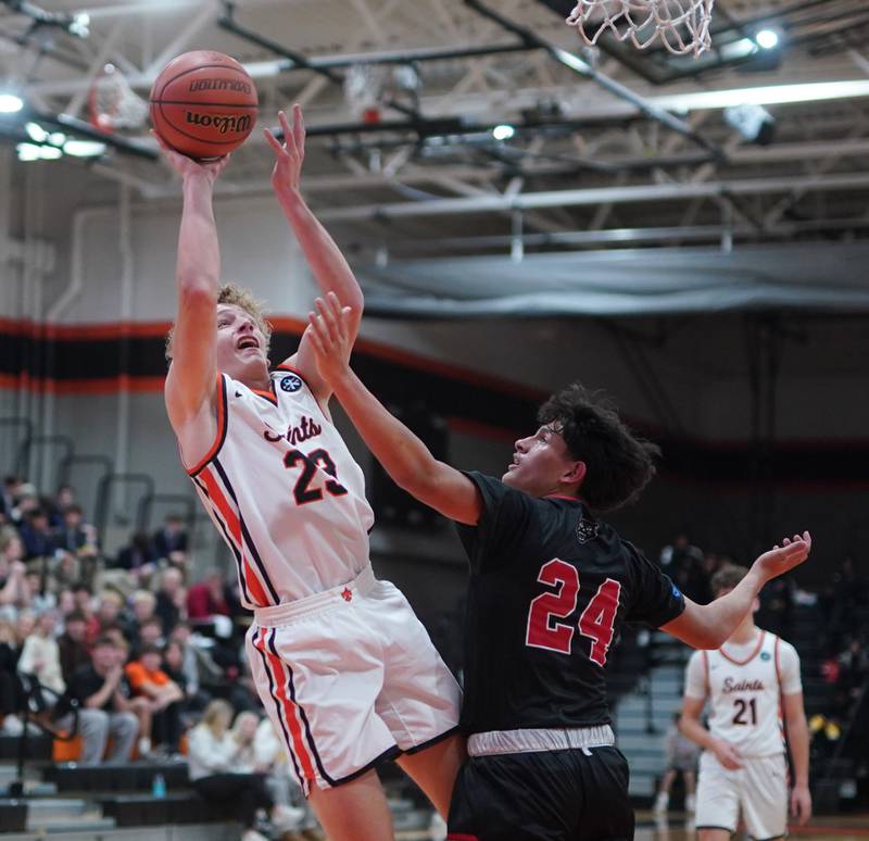 St. Charles East's Matt Steinberg (23) shoots the ball in the post over East Aurora's Luis Umana (24) during the 64th annual Ron Johnson Thanksgiving Basketball Tournament at St. Charles East High School on Monday, Nov 20, 2023.