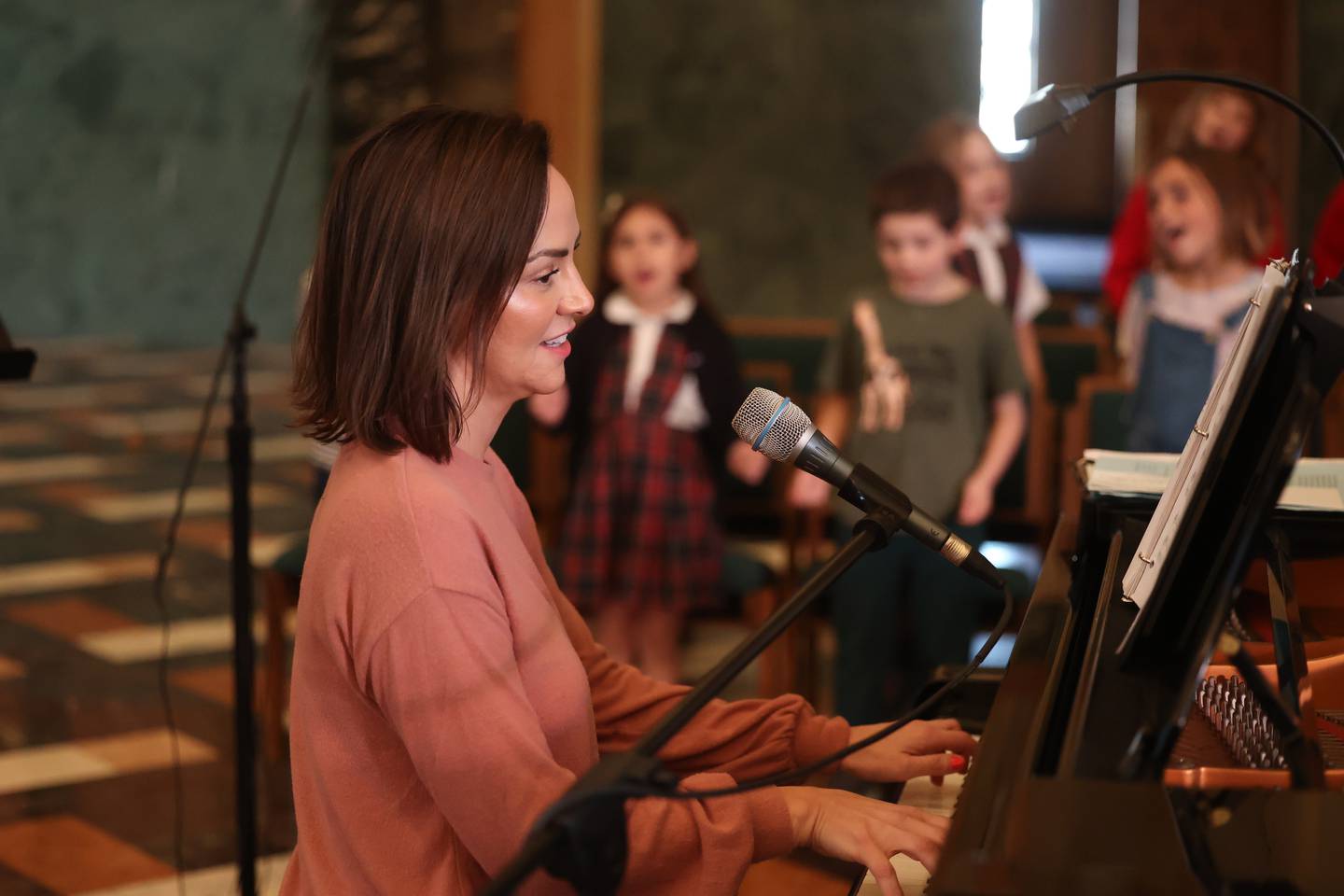 Stacy Sienko leads the children’s choir rehearsal at the Cathedral of Saint Raymond Nonnatus for the upcoming A Very Rialto Christmas show.