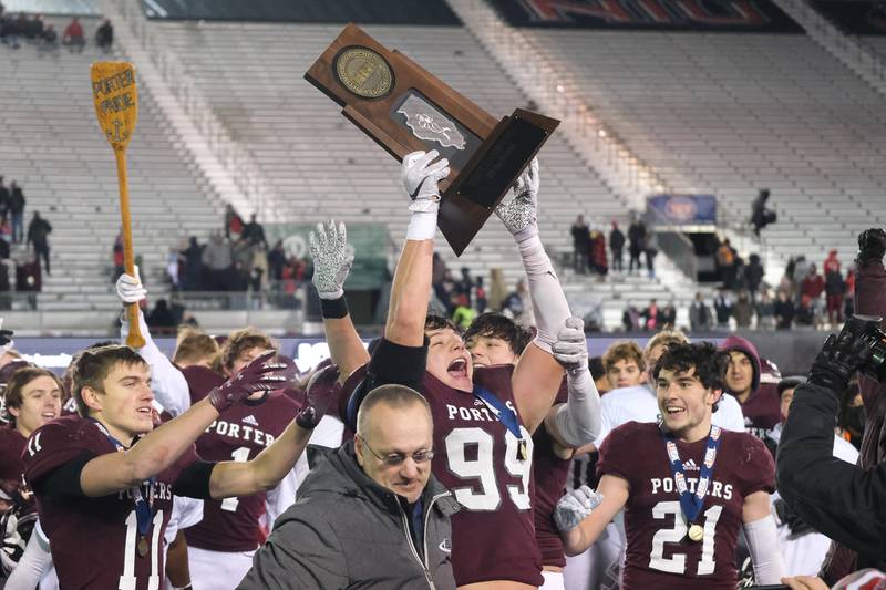 Lockport's Cody Silzer holds up the championship trophy after their 24-6 win against Maine South in the Class 8A state championship on Nov. 27, 2021 at NIU's Huskie Stadium in DeKalb.