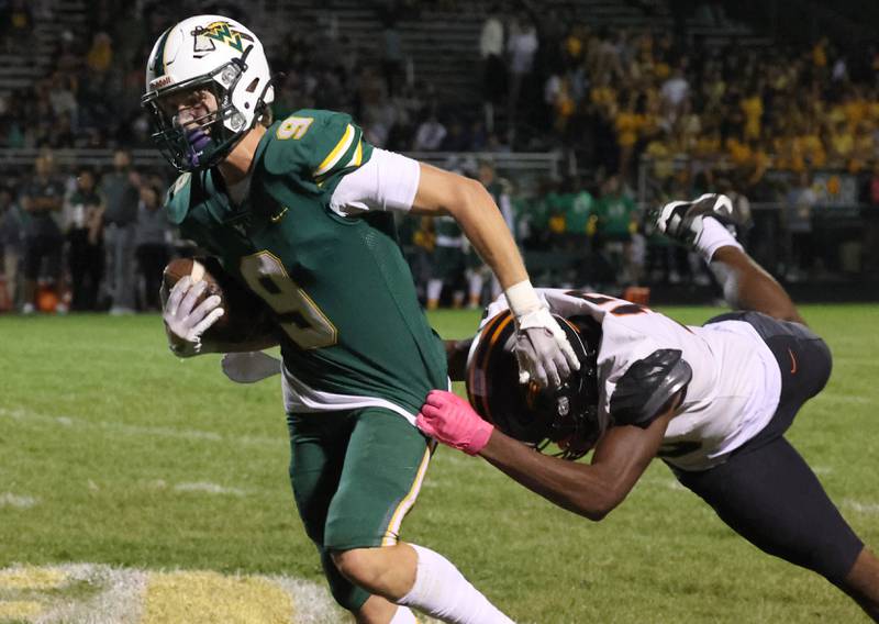 Waubonsie Valley’s Owen Roberts tries to pull away from DeKalb's Davon Grant during their game Friday, Oct. 11, 2024, at Waubonsie Valley High School in Aurora.