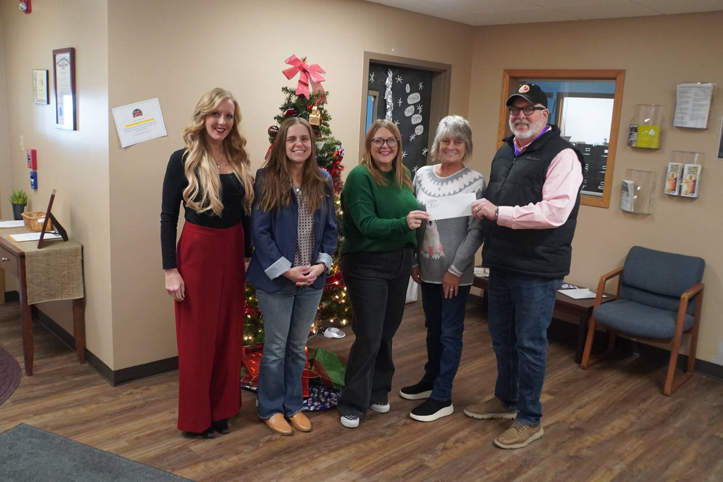 From left to right: Rochelle Area Community Foundation Executive Director Emily Anaya and Focus House staff accept a Future of Focus House fund designation from Dina and John Bearrows of Rochelle.