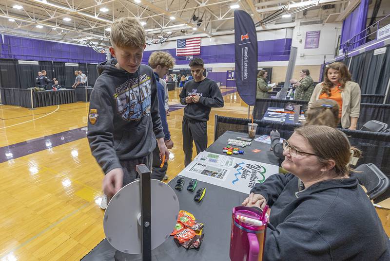Brody Hopper spins a prize wheel at the Woodhaven Lake’s booth Wednesday, March 11, 2026, at Dixon High School. Students were invited in to speak with local companies about career options during the career fair.