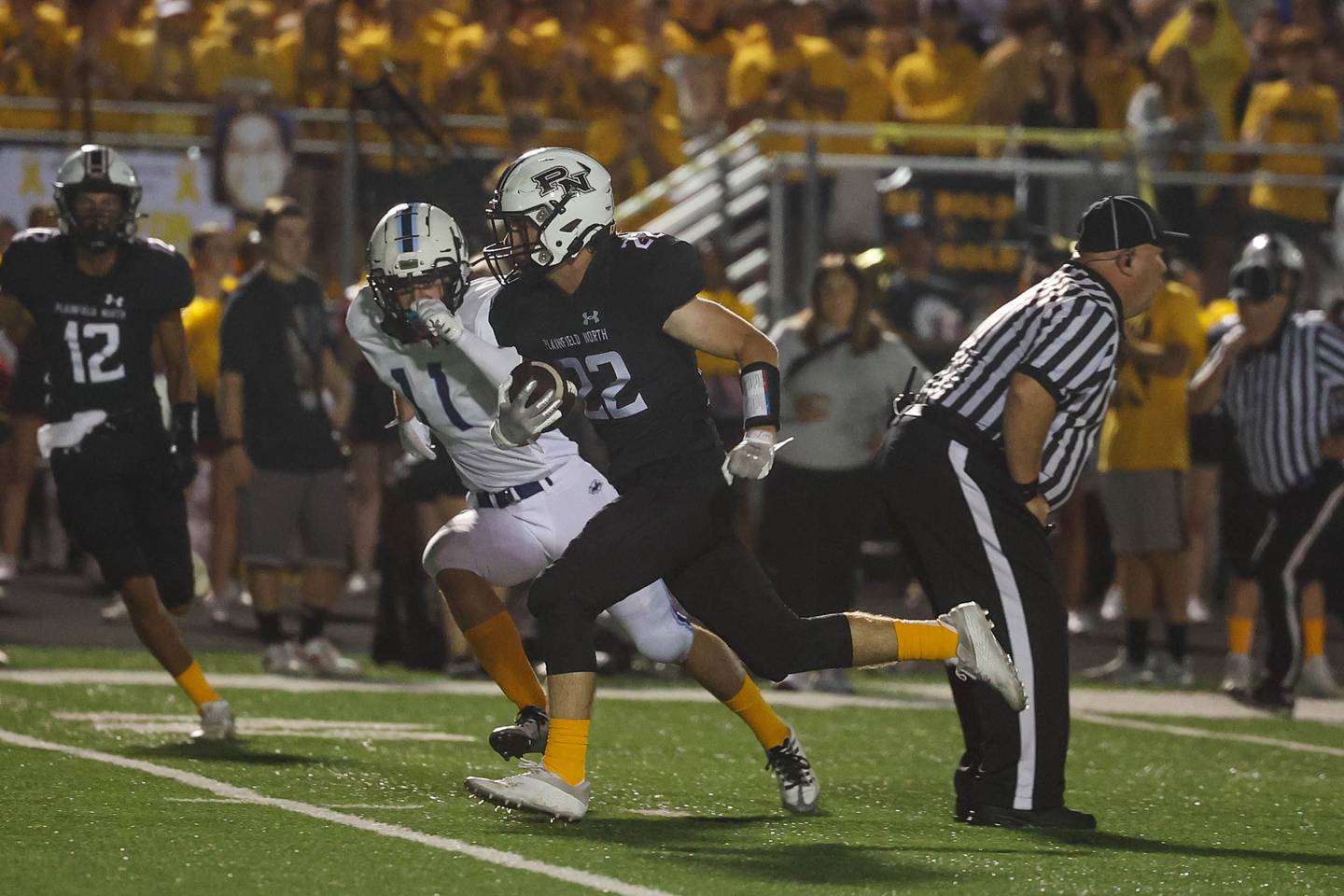 Plainfield North’s John St. Clair breaks through the middle against Plainfield South. Thursday, Sept. 15, 2022, in Plainfield.