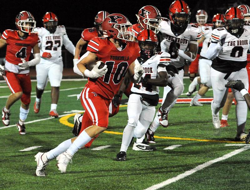 Yorkville running back Luke Zook (10) finds room on the outside against the Bolingbrook defense on Friday, Sept. 27, 2024, during a varsity game at Yorkville High School.