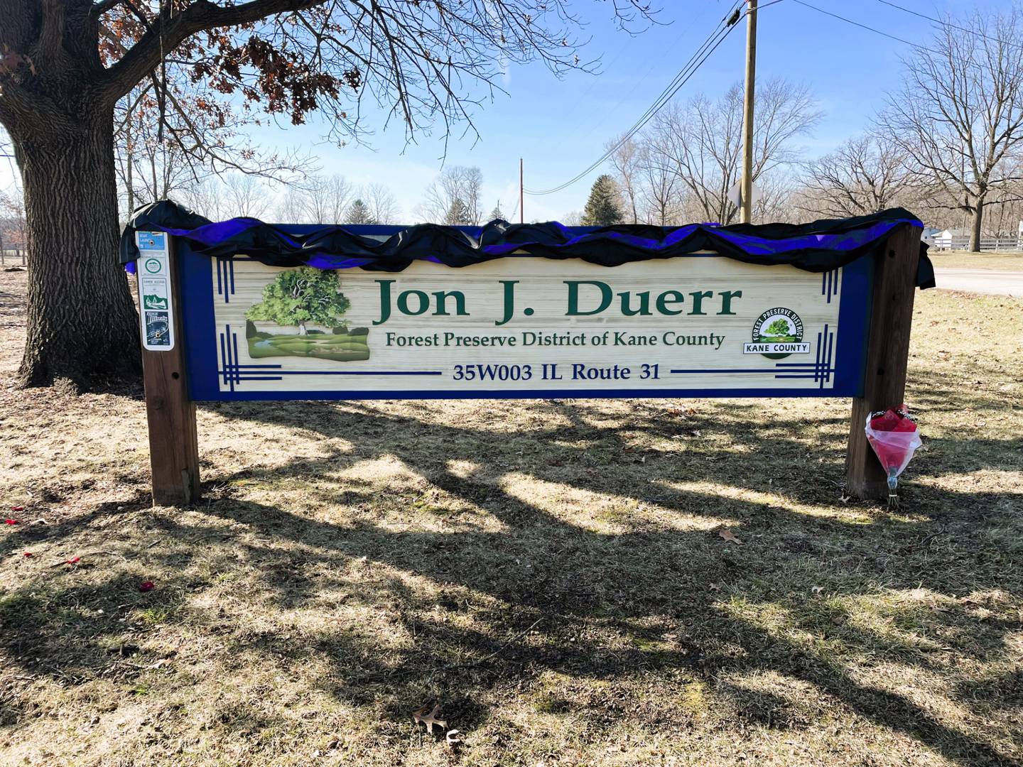 Black bunting was placed on the sign for the Kane County Jon J. Duerr Forest Preserve. Duerr died Tuesday while in hospice care for cancer. He was 81.