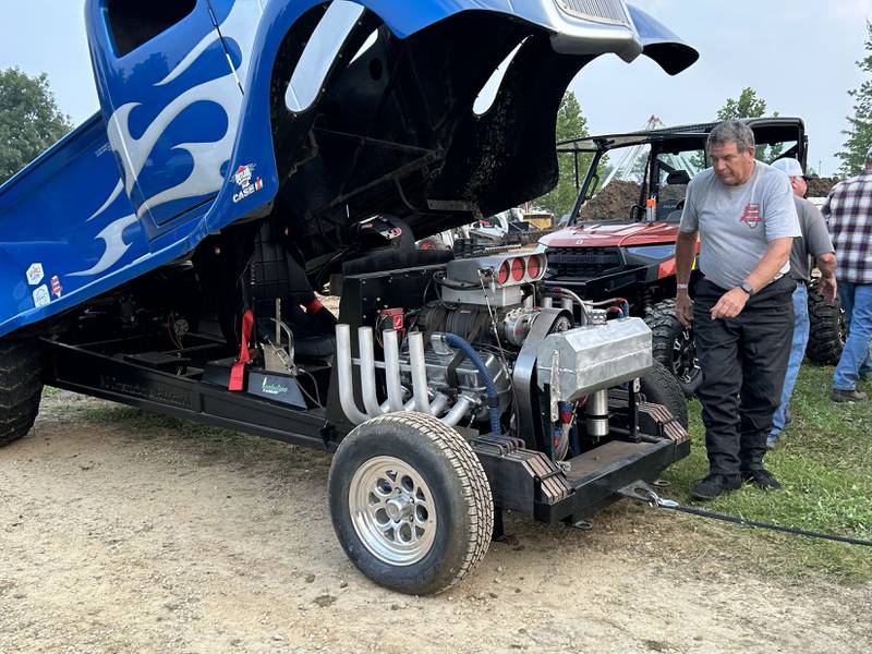 Tom Venhuizen of Morrison looks over the engine of his 36 Chevy modified tractor "The Fun End" after making a run in the open division at the Ogle County Fair's  tractor pull in Oregon on Thursday, July 31, 2025