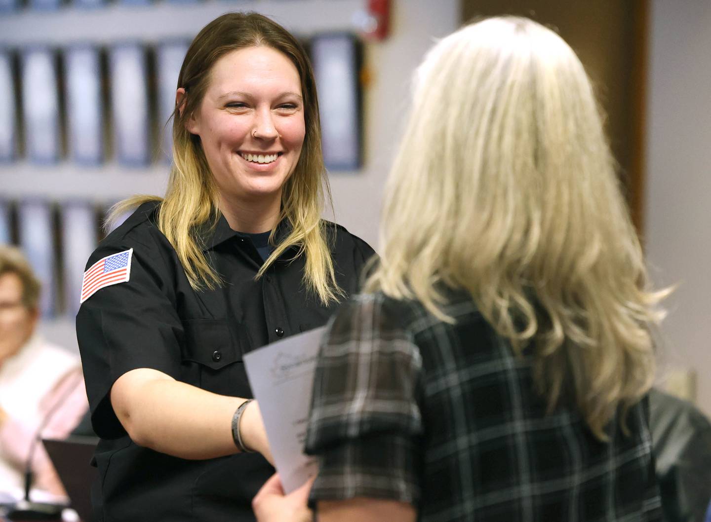 New Sycamore firefighter KeeLey Meyer smiles after being officially sworn in by city clerk Mary Kalk Monday, April 1, 2024, during the Sycamore City Council meeting in the chambers at Sycamore Center.