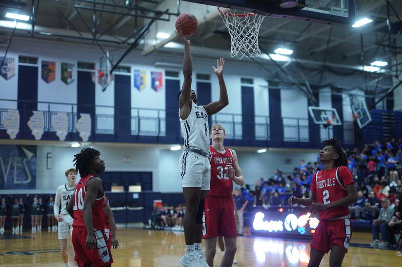 Oswego East's Andrew Wiggins (1) shoots the ball in the post against Yorkville's Jason Jakstys (32) during a basketball game at Oswego East High School on Friday, Dec 8, 2023.