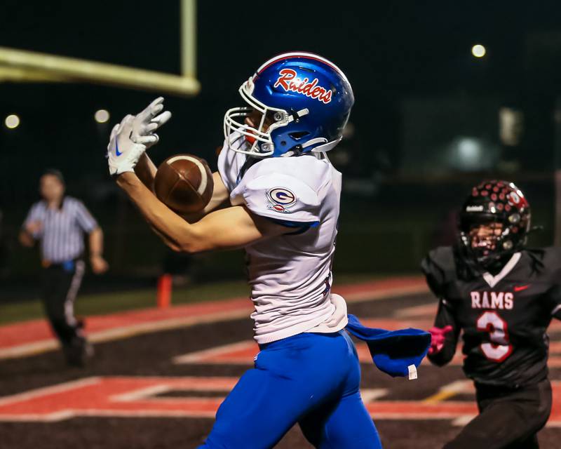 Glenbard South's Anthony Colby (11) catches a touchdown during football game between Glenbard South at Glenbard East.   Oct 13, 2023.