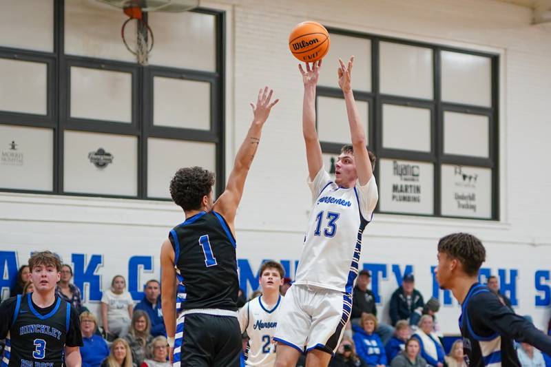 Newark’s Dylan Long (13) shoots the ball in the paint over Hinckley-Big Rock's Sawyer Smith (1) during a basketball game at Newark High School on Tuesday, January 28, 2025.
