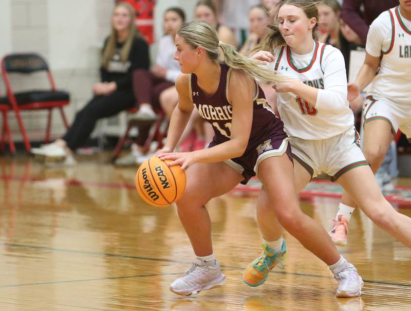 Morris's Alyssa Jepsen gets in front of L-P's Ella McCuley to drive to the hoop on Monday, Feb. 9, 2026 in Sellett Gymnasium at L-P High School.