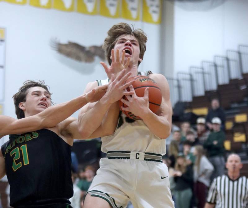 Crystal Lake South’s Cooper LePage, left, battles Grayslake Central’s Jake Kruse during Hinkle Holiday Classic Basketball Tournament title game action at Jacobs High School Friday.