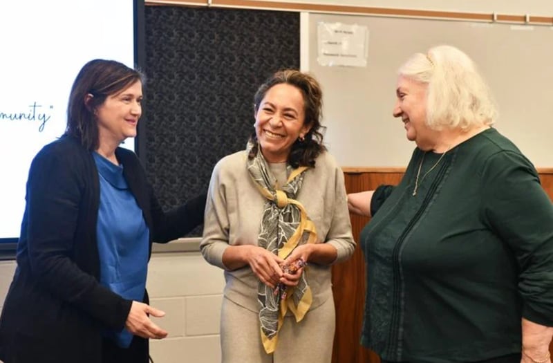 Lorenia Lara, center, smiles as she receives her Harold Award, a symbolic giraffe, from Brenda Wetzel, director of Life Education Center programming, left, and Deb Baron, former director of Project SUN, during the Pledge for Life Partnership’s Board of Directors meeting on Jan. 23.