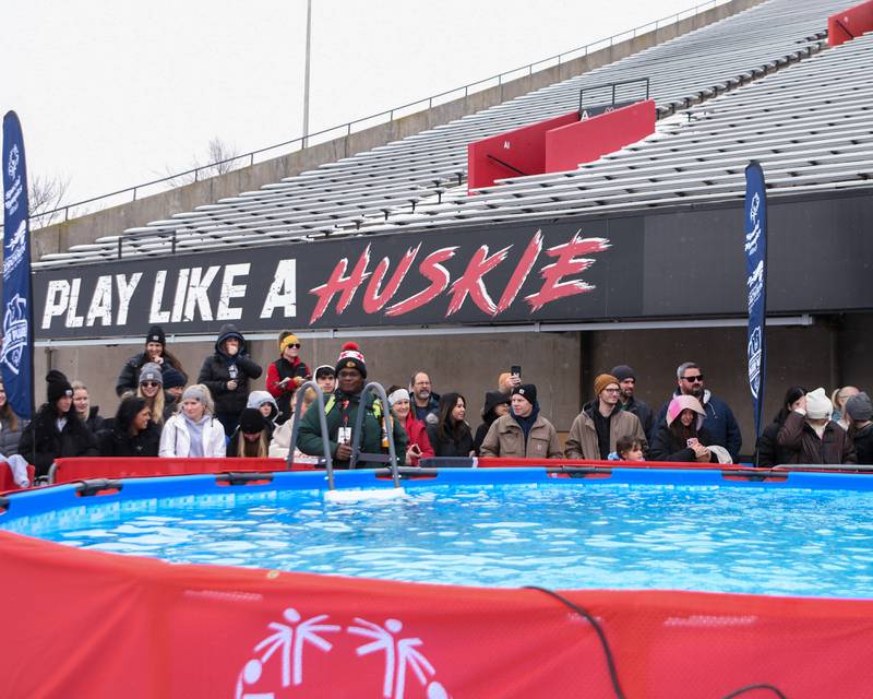 Spectators wait to watch participants expected to plunge into the bitter cold waters on Saturday, Feb. 15, 2025, during the 2nd annual Polar Plunge at Northern Illinois University's Huskie Stadium in DeKalb. Proceeds benefiting the law enforcement torch run for Special Olympics.