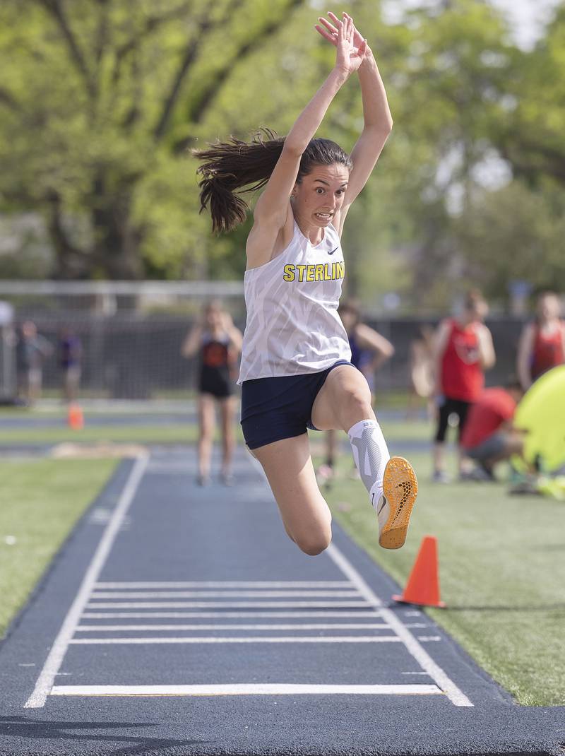 Sterling’s Alice Sotelo looks to land her triple jump attempt Thursday, May 11, 2023 at the class 2A Sterling girls track sectionals. Sotelo qualified to defend her triple jump state title.