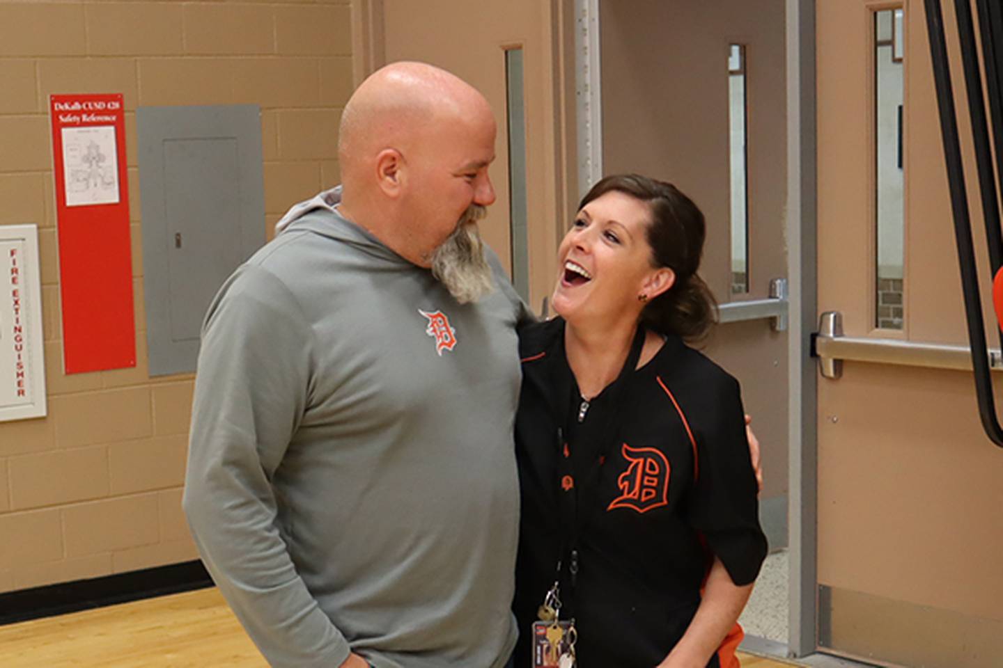 DeKalb School District 428 driver's education instructor and assistant athletic director Mark Sykes smiles with DeKalb High School Principal Donna Larson on April 25, 2025, at DeKalb High School, 501 W. Dresser Road. Sykes was surprised and named the 2025 Wirtz Award winner for excellence in education.