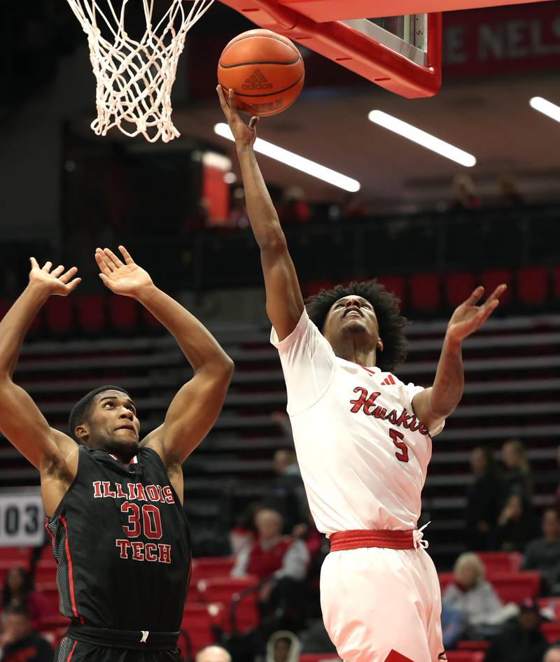 Northern Illinois' Philmon Gebrewhit scores in front of Illinois Tech's Garrison Carter during their game Monday, Nov. 13, 2023, at the NIU Convocation Center in DeKalb.