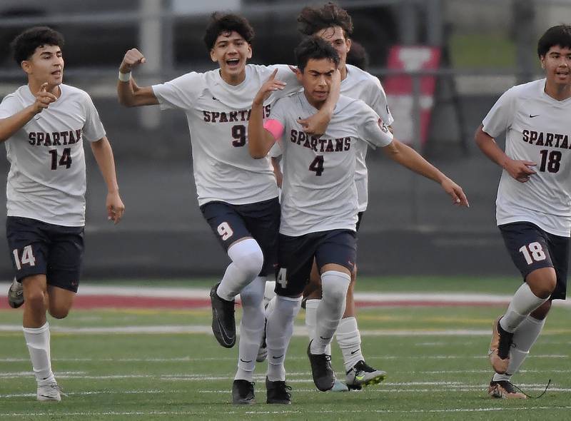 Romeoville’s Manny Casillas (4) celebrates his first-half goal against Naperville North with his teammates in the Class 3A Plainfield North High School boys soccer sectional semifinal game in Plainfield on Wednesday, October 25, 2023.