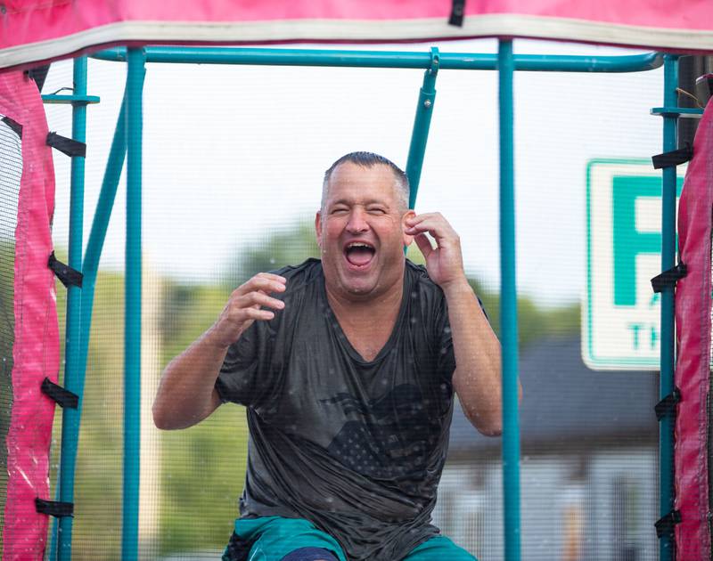 Algonquin Police Chief Dennis Walker laughs when a friend of his fails to dunk him in the dunk tank during the National Night Out in Old Town Algonquin on Tuesday, August 1, 2023.