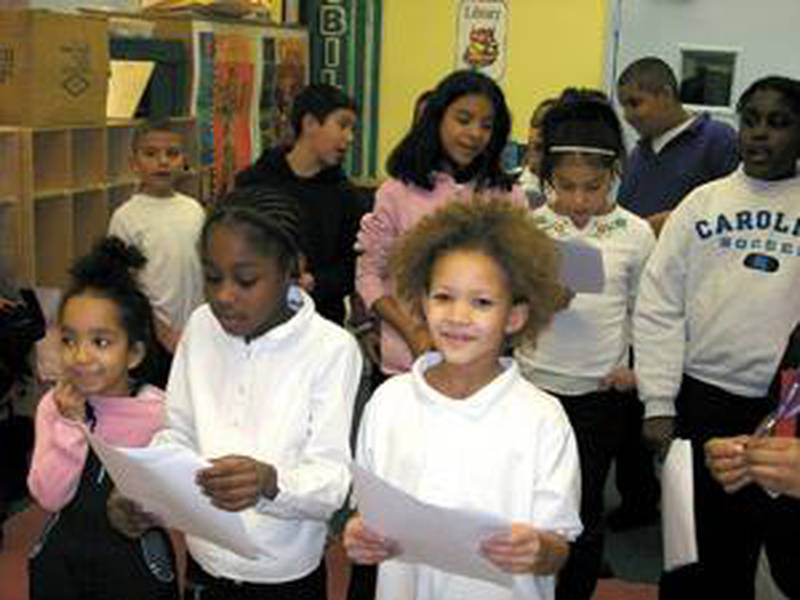 Children participate in a YWCA Lake County program practice singing Christmas songs. The YWCA in Waukegan offers child care and other assistance for working moms.  (Photo provided)